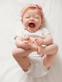 Laughing Caucasian baby girl